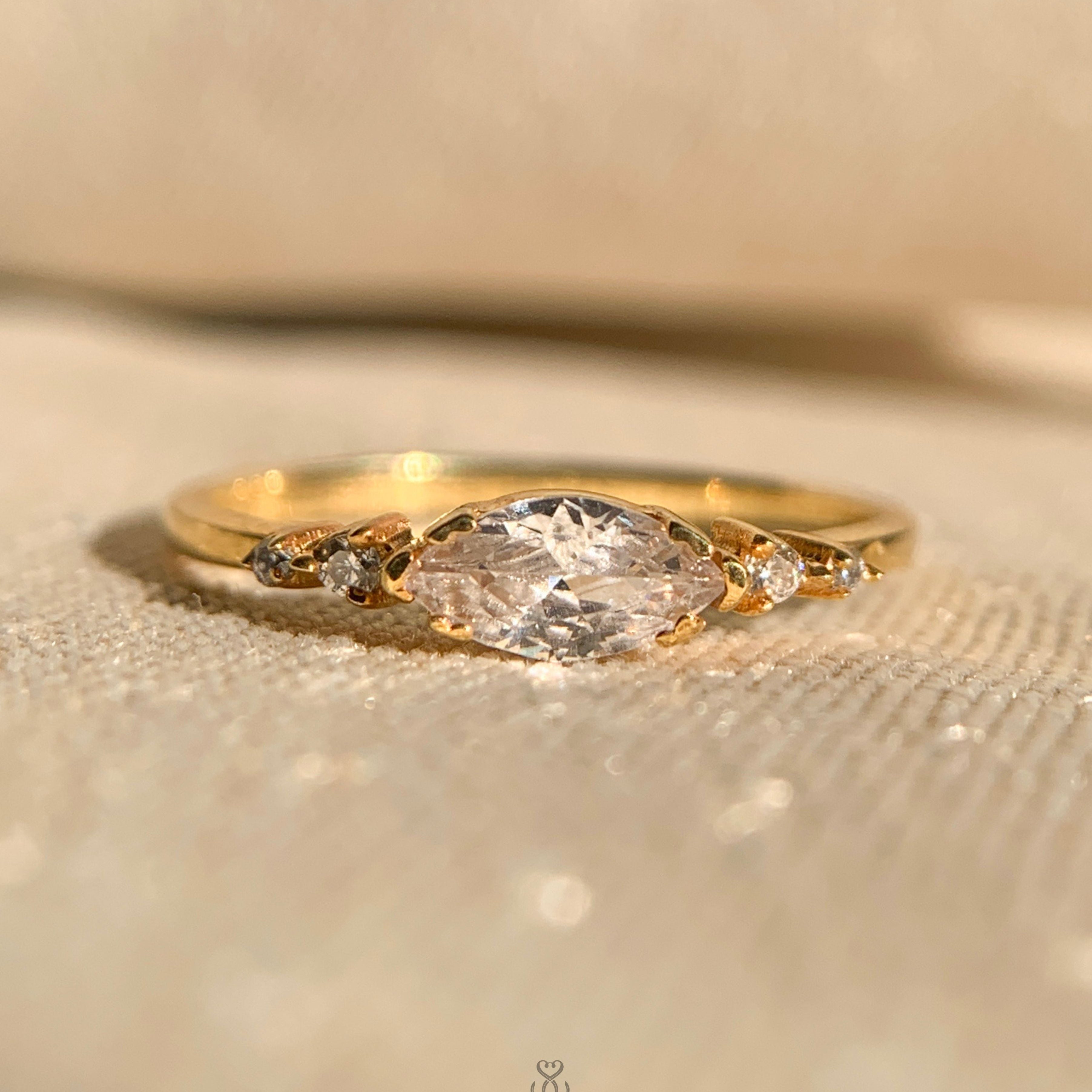 Gold east-west marquise diamond ring with sleek minimalist band